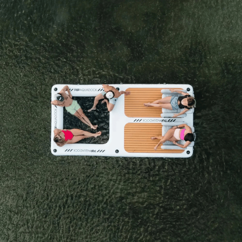 5 People relaxing on a POP AquaDock 14' × 7' Inflatable Floating Dock Platform