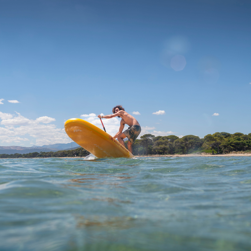 A man on Aqua Marina Fusion 10'10" all-around inflatable paddle board SUP