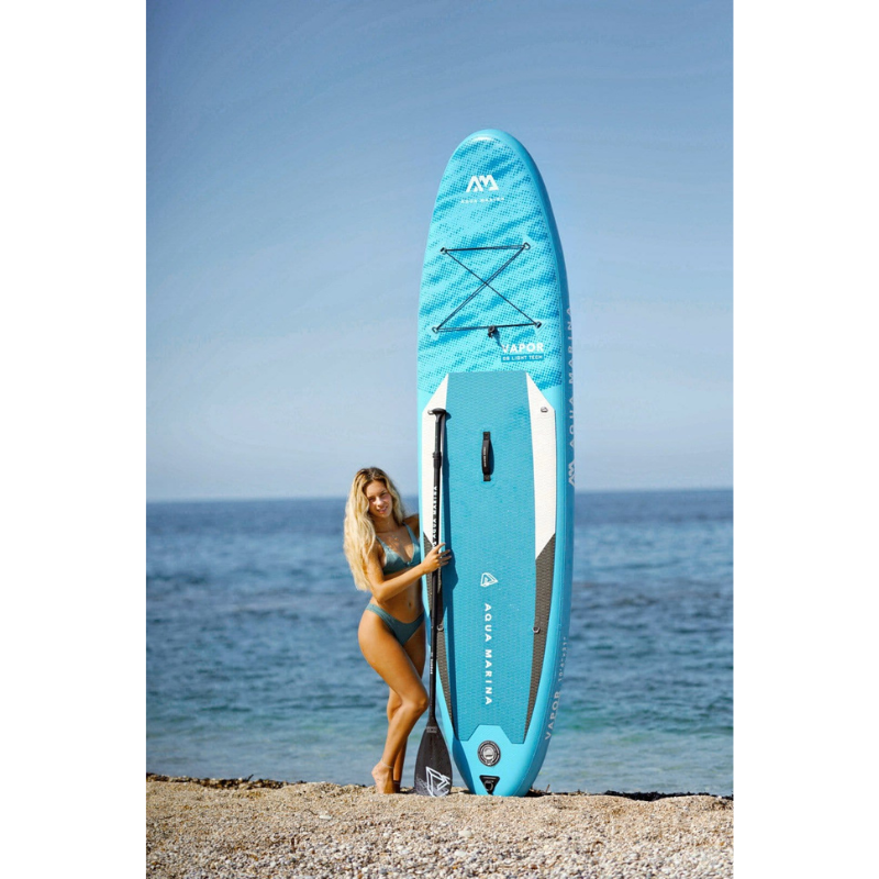An Woman with Aqua Marina 10'4" Vapor 2021 Inflatable Paddle Board SUP
