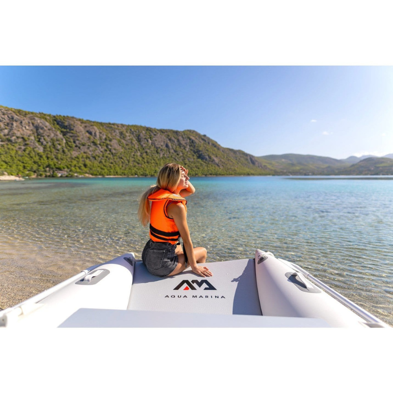 An Woman sitting on the stern of Two people riding Aqua Marina 9'4" x 63″ AIRCAT 2021/2022 Inflatable Catamaran Boat
