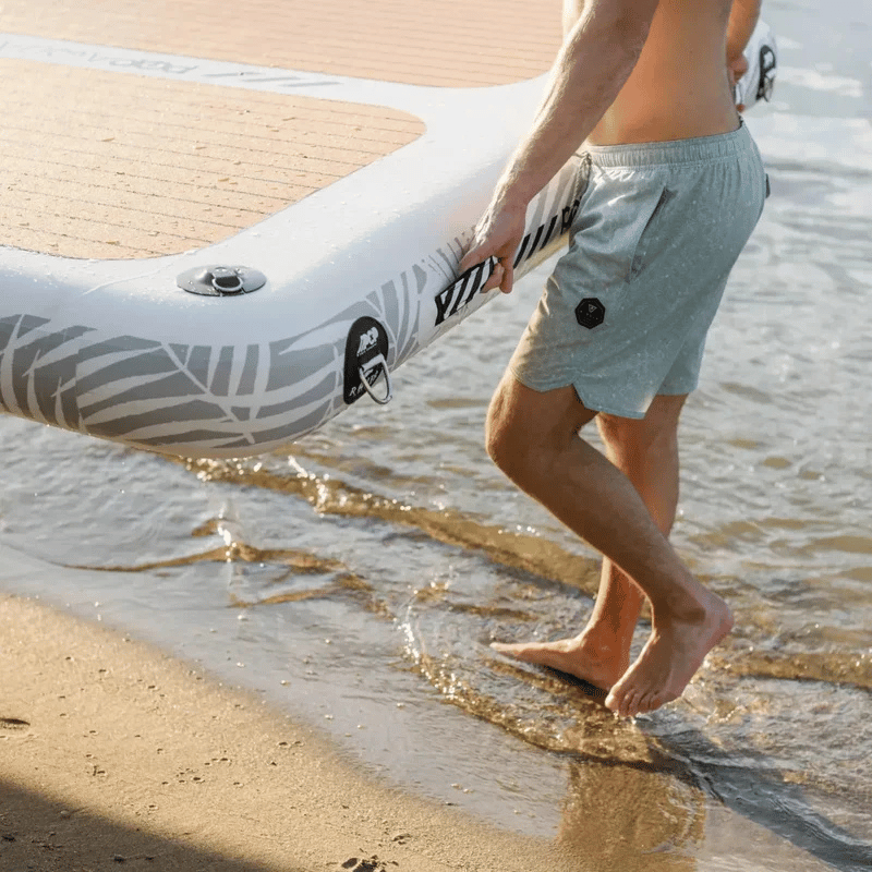 A person carrying a POP AquaDock 14' × 7' Inflatable Floating Dock