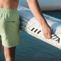 Thumbnail for A person carrying a POP YachtDock 14' Inflatable Floating Dock Platform with its Handle
