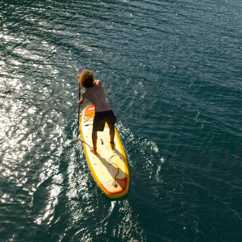 Back View of a man on a Aqua Marina Fusion 10'10" all-around inflatable paddle board
