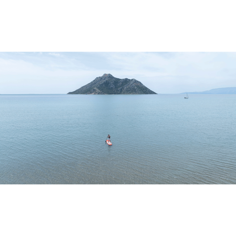 Zoomed out view of a person on a Aqua Marina 12'0" MONSTER 2026 Inflatable Paddle Board | All-Around SUP